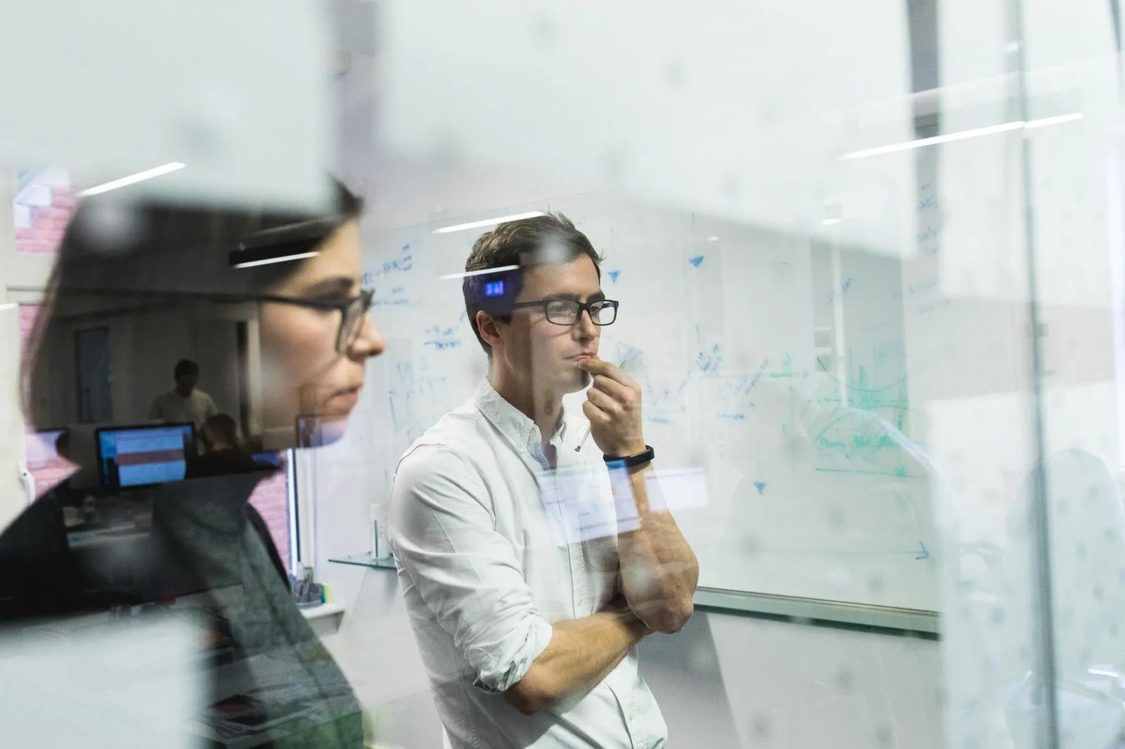 Strategy session at a glass whiteboard